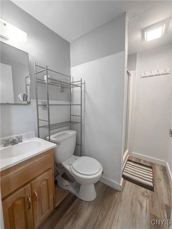 66 Groton Ave, Cortland, NY 13045 - bathroom featuring wood finished floors, vanity, and a shower stall