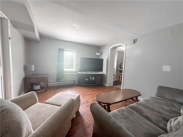 66 Groton Ave, Cortland, NY 13045 - living area with arched walkways, wood finished floors, and a baseboard heating unit