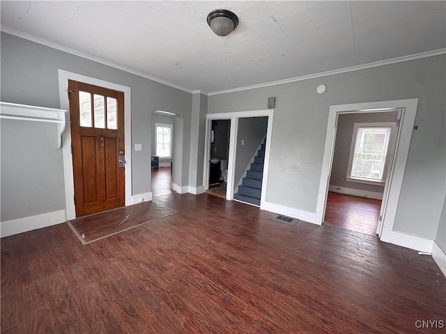 66 Groton Ave, Cortland, NY 13045 - foyer entrance featuring healthy amount of natural light, arched walkways, wood finished floors, and crown molding