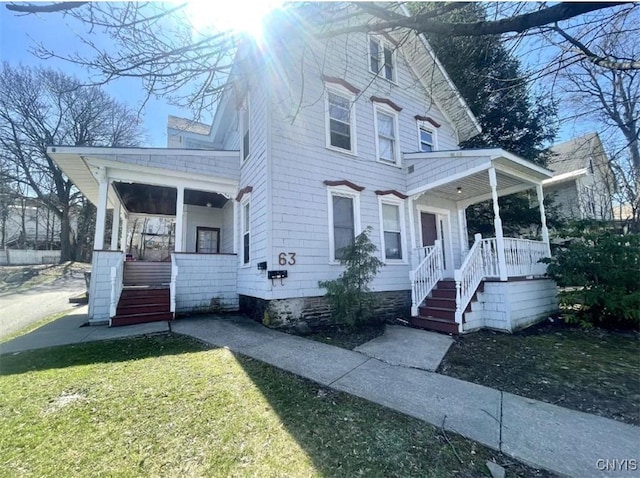 63 Groton Ave, Cortland, NY 13045 - view of front of home with a porch, stairway, and a front lawn