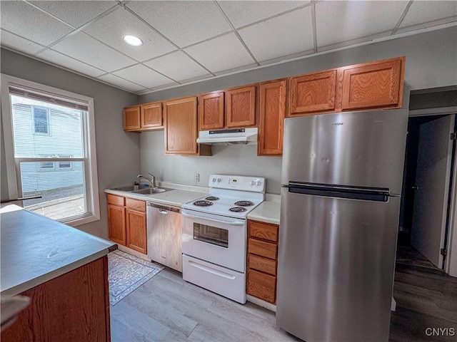63 Groton Ave, Cortland, NY 13045 - kitchen with appliances with stainless steel finishes, under cabinet range hood, light wood-style flooring, light countertops, and brown cabinetry