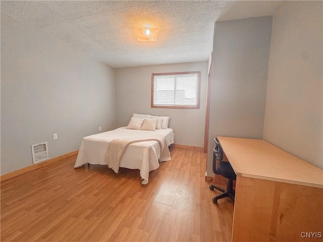 63 Groton Ave, Cortland, NY 13045 - bedroom with light wood-style flooring and a textured ceiling