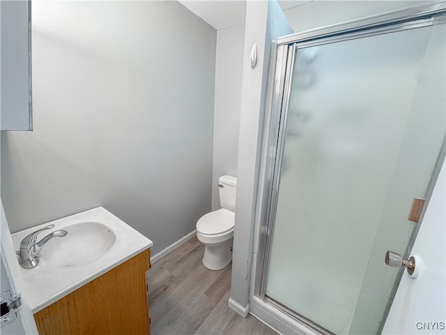 63 Groton Ave, Cortland, NY 13045 - full bathroom with a stall shower, vanity, and wood finished floors