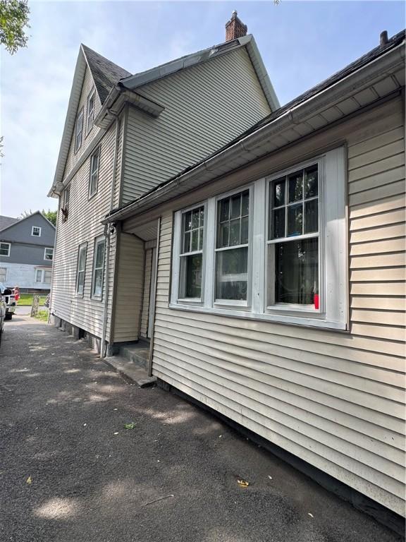 280 Ave D, Rochester, NY 14621 - view of side of property with a chimney
