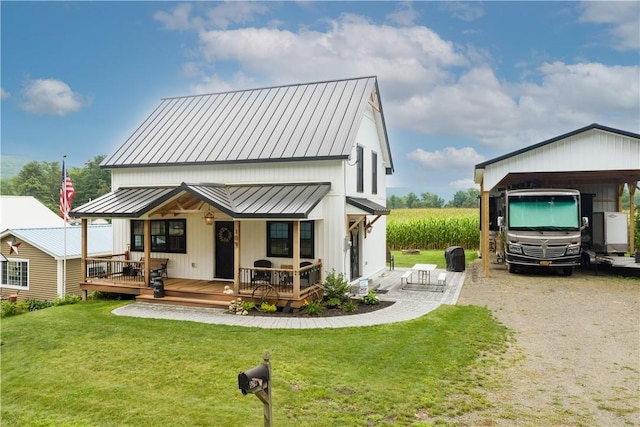 109 Unadilla Trail Rd, Pittsfield, NY 13411 - rear view of house featuring a lawn, covered porch, a standing seam roof, and a metal roof