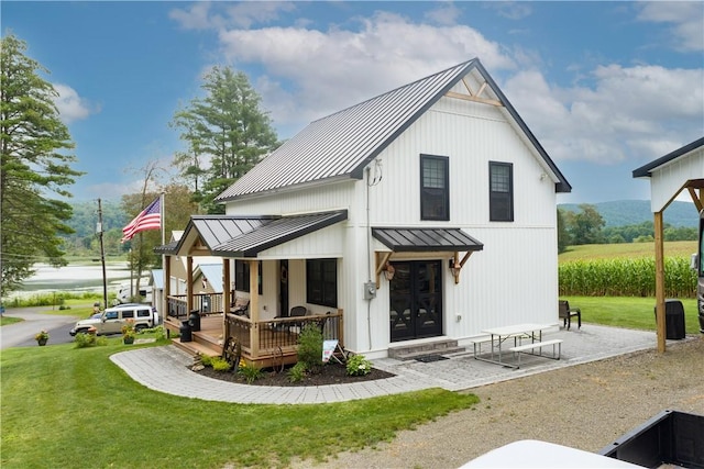 109 Unadilla Trail Rd, Pittsfield, NY 13411 - rear view of house featuring a standing seam roof, a metal roof, a yard, and a porch
