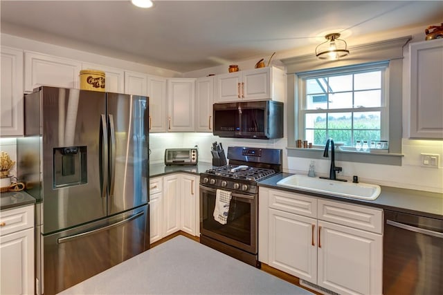 109 Unadilla Trail Rd, Pittsfield, NY 13411 - kitchen featuring appliances with stainless steel finishes, white cabinets, dark countertops, and recessed lighting