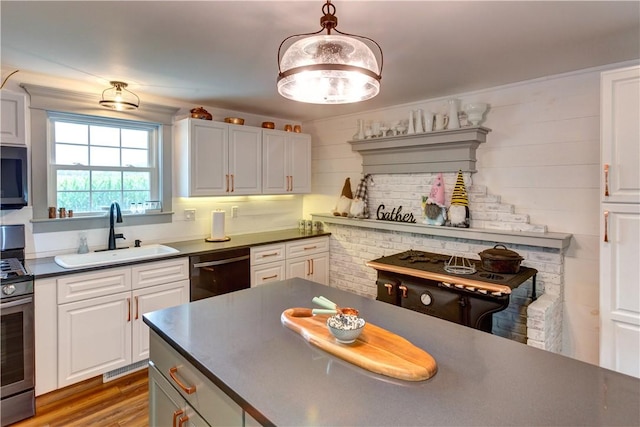 109 Unadilla Trail Rd, Pittsfield, NY 13411 - kitchen with stainless steel appliances, dark countertops, white cabinetry, and wood finished floors