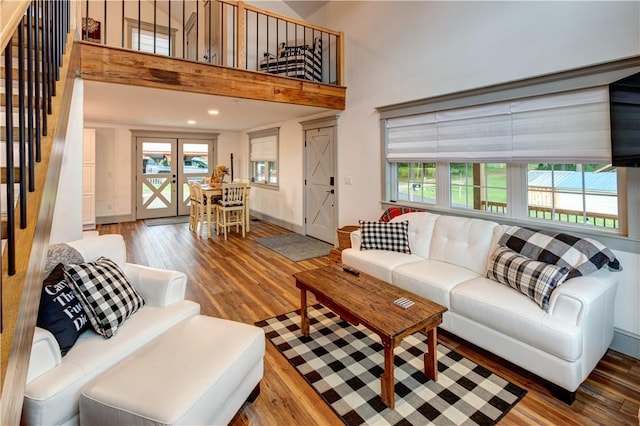 109 Unadilla Trail Rd, Pittsfield, NY 13411 - living area with wood finished floors, plenty of natural light, french doors, a towering ceiling, and recessed lighting
