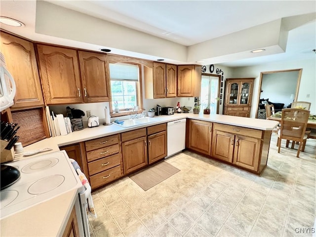 2 Whitetail Cir, Oswego-City, NY 13126 - kitchen featuring white appliances, brown cabinets, a peninsula, and light countertops