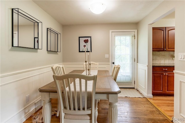 368 Northfield Way, Camillus, NY 13031 - dining area featuring light wood finished floors, wainscoting, and a decorative wall