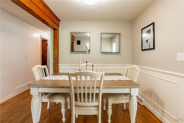 368 Northfield Way, Camillus, NY 13031 - dining room with wood finished floors, a wainscoted wall, and a decorative wall