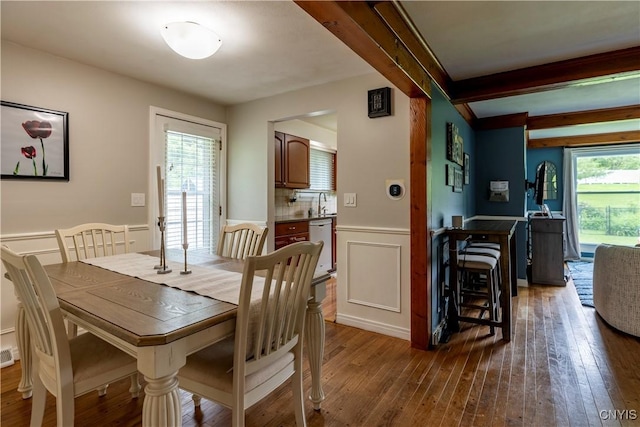 368 Northfield Way, Camillus, NY 13031 - dining space featuring hardwood / wood-style floors, wainscoting, beamed ceiling, and a decorative wall