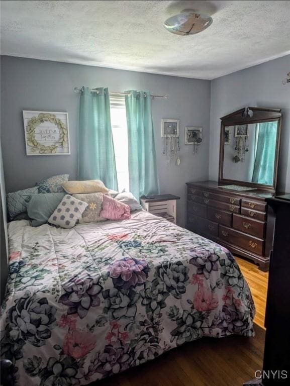 538 Seneca St, Oneida-Inside, NY 13421 - bedroom featuring wood finished floors and a textured ceiling