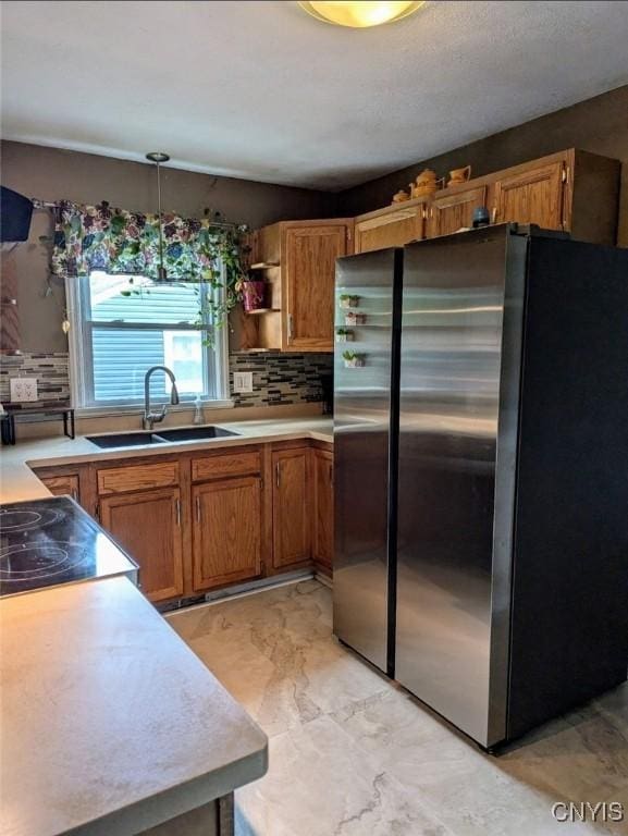 538 Seneca St, Oneida-Inside, NY 13421 - kitchen featuring freestanding refrigerator, tasteful backsplash, brown cabinetry, light countertops, and light marble finish floors