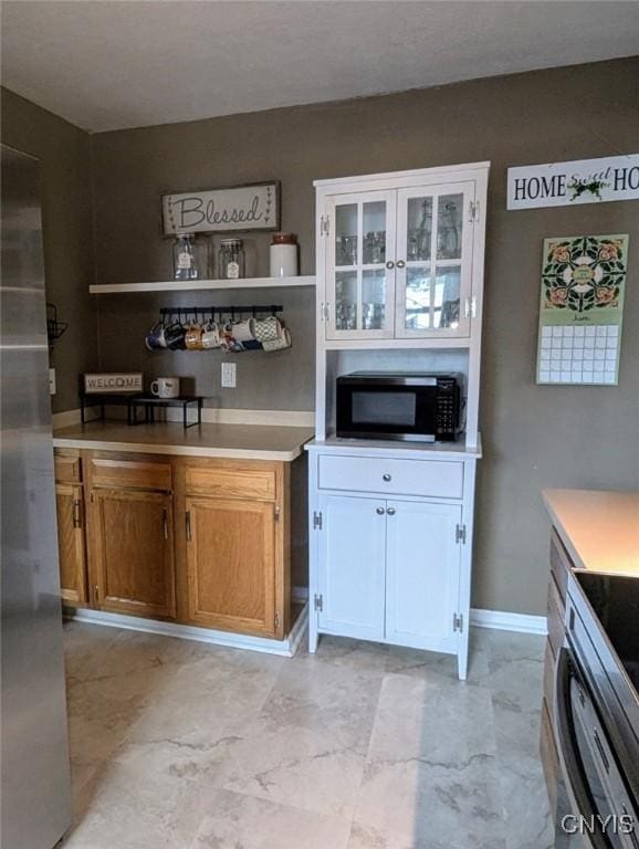 538 Seneca St, Oneida-Inside, NY 13421 - kitchen with stainless steel appliances, light countertops, open shelves, and brown cabinets