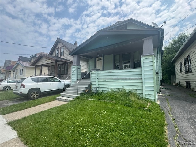 79 Freund St, Buffalo, NY 14215 - view of front of home with covered porch and a front lawn