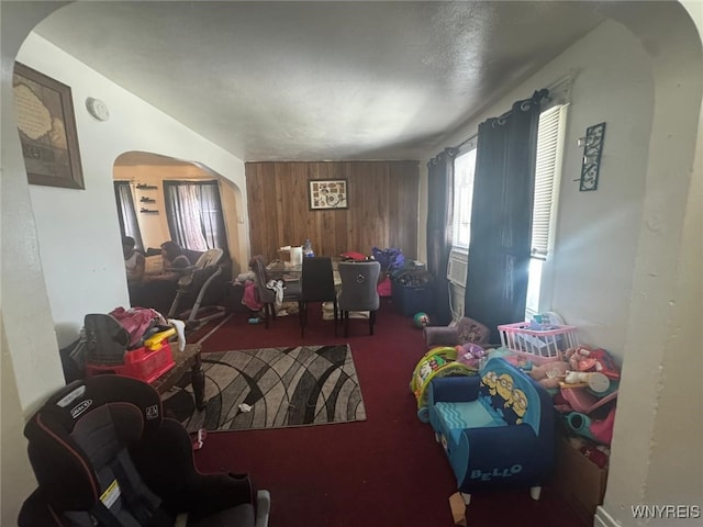 79 Freund St, Buffalo, NY 14215 - carpeted living area with arched walkways and wood walls