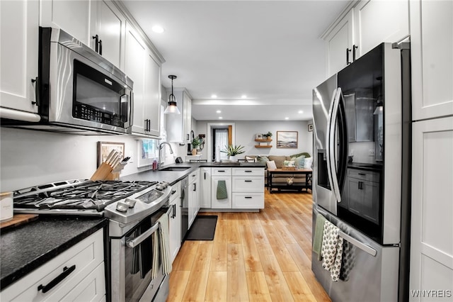 17 E Ave, Leroy, NY 14482 - kitchen with stainless steel appliances, dark countertops, light wood-type flooring, a peninsula, and recessed lighting