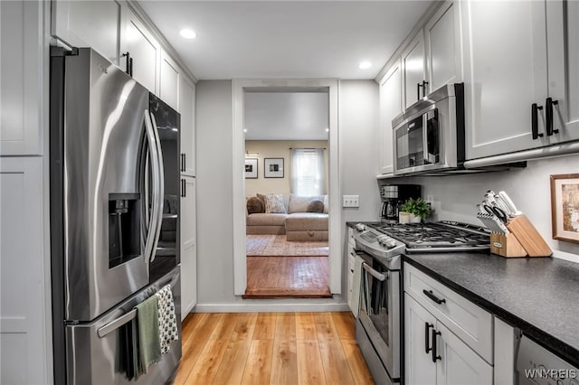 17 E Ave, Leroy, NY 14482 - kitchen featuring stainless steel appliances, light wood-style floors, dark countertops, recessed lighting, and white cabinetry
