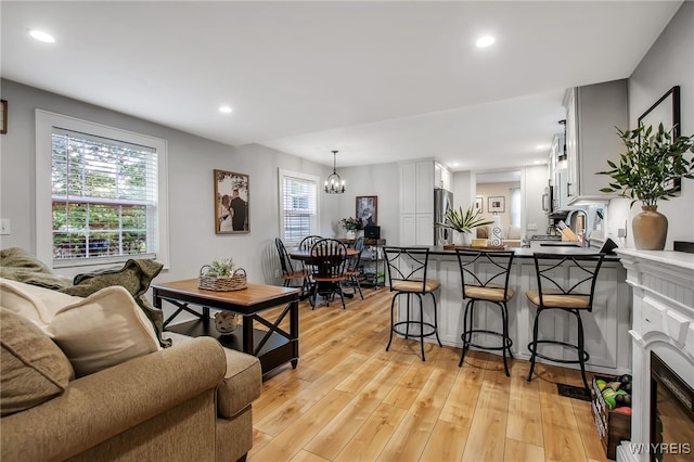 17 E Ave, Leroy, NY 14482 - living room featuring light wood finished floors, a chandelier, recessed lighting, and a fireplace with flush hearth