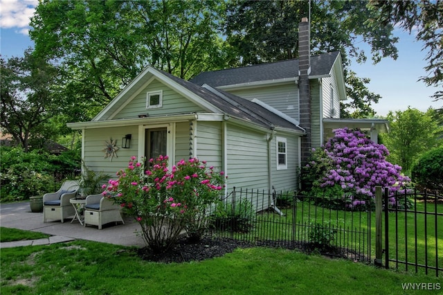 17 E Ave, Leroy, NY 14482 - view of home's exterior with a chimney, roof with shingles, and a patio area