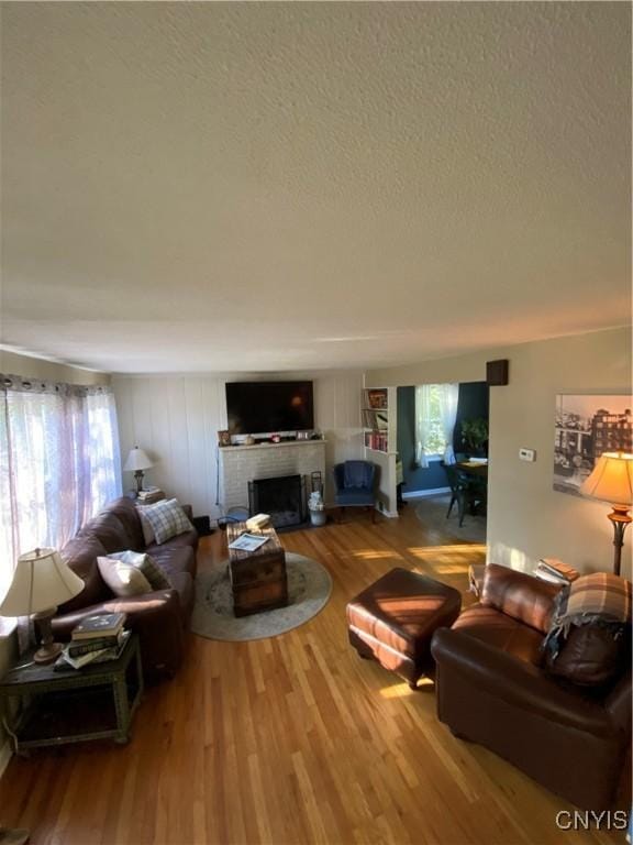 131 Wheaton Rd, Syracuse, NY 13203 - living room featuring a textured ceiling, wood finished floors, and a fireplace