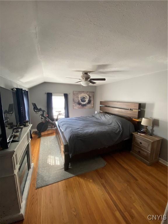 131 Wheaton Rd, Syracuse, NY 13203 - bedroom featuring light wood-style floors, vaulted ceiling, a ceiling fan, and a textured ceiling