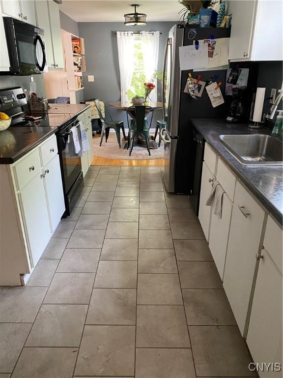 131 Wheaton Rd, Syracuse, NY 13203 - kitchen featuring black appliances, dark countertops, white cabinets, and light tile patterned flooring