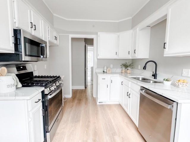22 Yorkshire Rd, Irondequoit, NY 14609 - kitchen featuring stainless steel appliances, light wood-type flooring, and white cabinets
