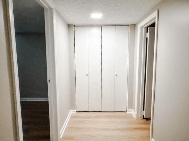 22 Yorkshire Rd, Irondequoit, NY 14609 - hallway featuring light wood finished floors and a textured ceiling