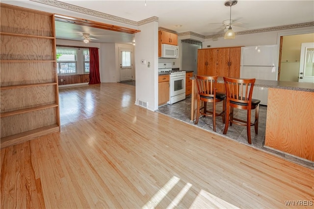 18 Eisenhower Dr, Lockport-City, NY 14094 - kitchen featuring white appliances, a ceiling fan, wood finished floors, and dark countertops