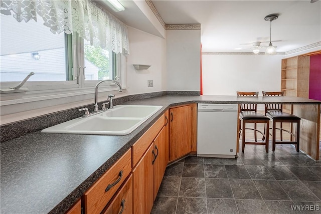 18 Eisenhower Dr, Lockport-City, NY 14094 - kitchen with white dishwasher, dark countertops, a ceiling fan, brown cabinetry, and ornamental molding