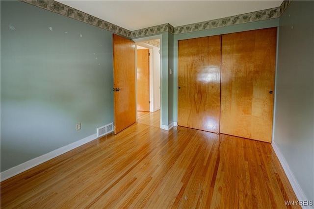 18 Eisenhower Dr, Lockport-City, NY 14094 - unfurnished bedroom featuring light wood-type flooring and a closet