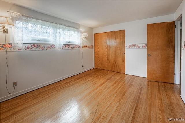 18 Eisenhower Dr, Lockport-City, NY 14094 - unfurnished bedroom with wood finished floors and a closet