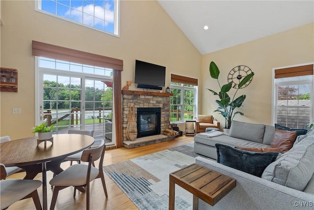 84 Krystyna Ln Unit 6, Cato, NY 13080 - living room featuring high vaulted ceiling, a stone fireplace, and light wood-style flooring