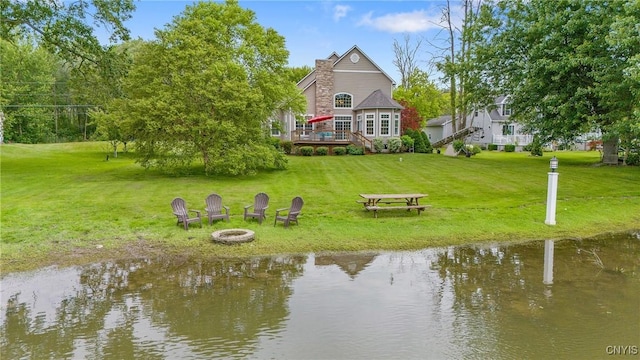 84 Krystyna Ln Unit 6, Cato, NY 13080 - back of house with an outdoor fire pit, a deck with water view, and a yard