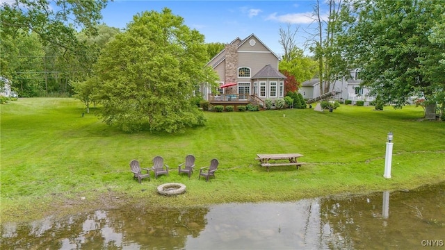 84 Krystyna Ln Unit 6, Cato, NY 13080 - back of property with a fire pit, a deck with water view, and a lawn
