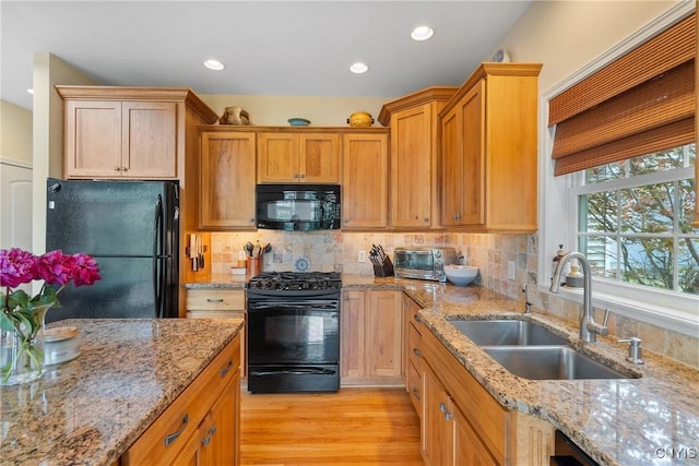 84 Krystyna Ln Unit 6, Cato, NY 13080 - kitchen featuring black appliances, light wood-type flooring, recessed lighting, tasteful backsplash, and light stone counters