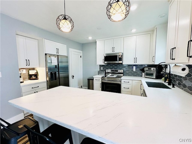 300 Hillsdale Ave, Syracuse, NY 13206 - kitchen featuring appliances with stainless steel finishes, backsplash, a peninsula, light stone counters, and recessed lighting