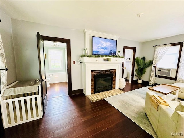 300 Hillsdale Ave, Syracuse, NY 13206 - living room featuring dark wood-type flooring, plenty of natural light, a brick fireplace, and cooling unit