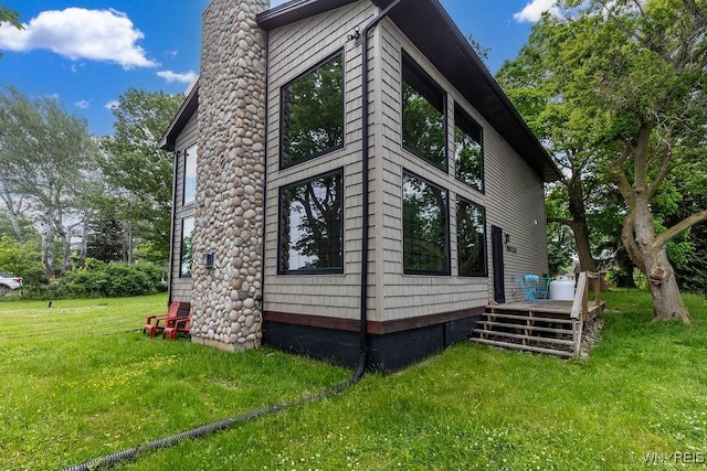2300 Washington Ave, Wilson, NY 14172 - view of home's exterior with a lawn and a chimney