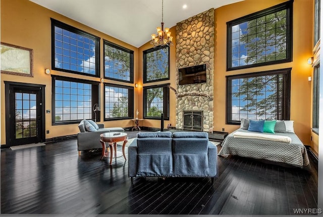 2300 Washington Ave, Wilson, NY 14172 - living area with a chandelier, a towering ceiling, a fireplace, plenty of natural light, and wood finished floors