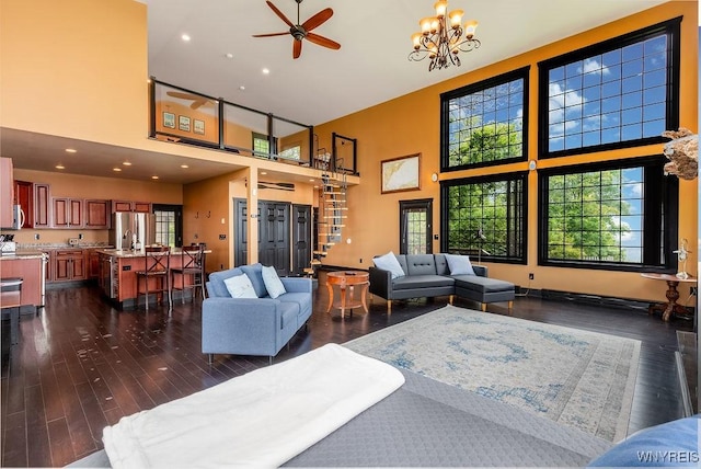 2300 Washington Ave, Wilson, NY 14172 - living room featuring a high ceiling, ceiling fan, dark wood-type flooring, recessed lighting, and a chandelier