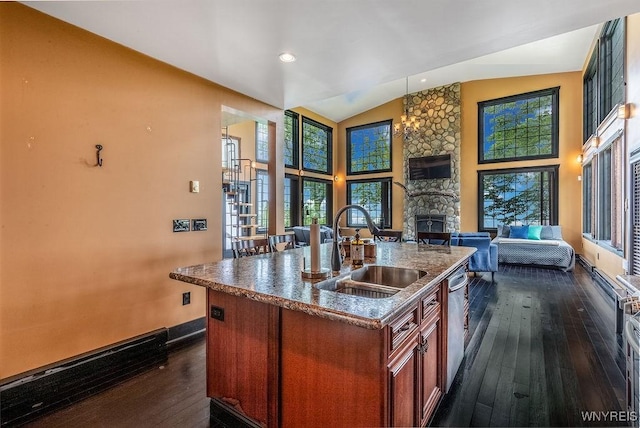 2300 Washington Ave, Wilson, NY 14172 - kitchen featuring open floor plan, dark wood-type flooring, an island with sink, a stone fireplace, and vaulted ceiling