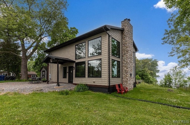2300 Washington Ave, Wilson, NY 14172 - back of property with a chimney and a lawn
