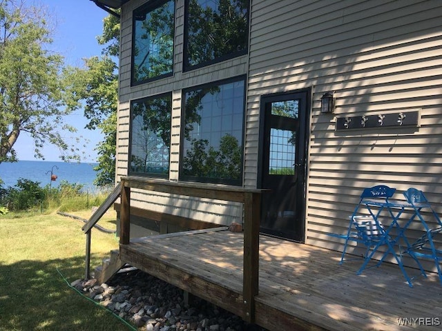 2300 Washington Ave, Wilson, NY 14172 - view of exterior entry with a deck with water view and a lawn