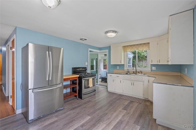 130 Hillcrest Rd, Onondaga, NY 13219 - kitchen featuring stainless steel appliances, light wood finished floors, white cabinets, and light countertops