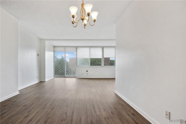1088 Delaware Ave Unit 3B, Buffalo, NY 14209 - unfurnished room with a chandelier, wood finished floors, and a textured ceiling