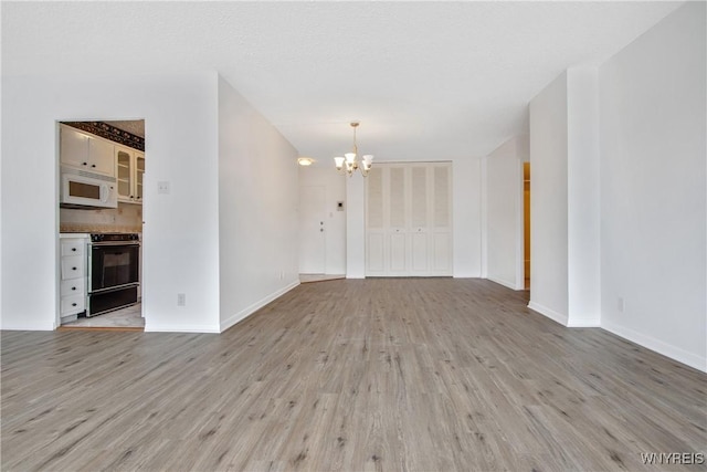 1088 Delaware Ave Unit 3B, Buffalo, NY 14209 - unfurnished room featuring a chandelier and light wood-type flooring